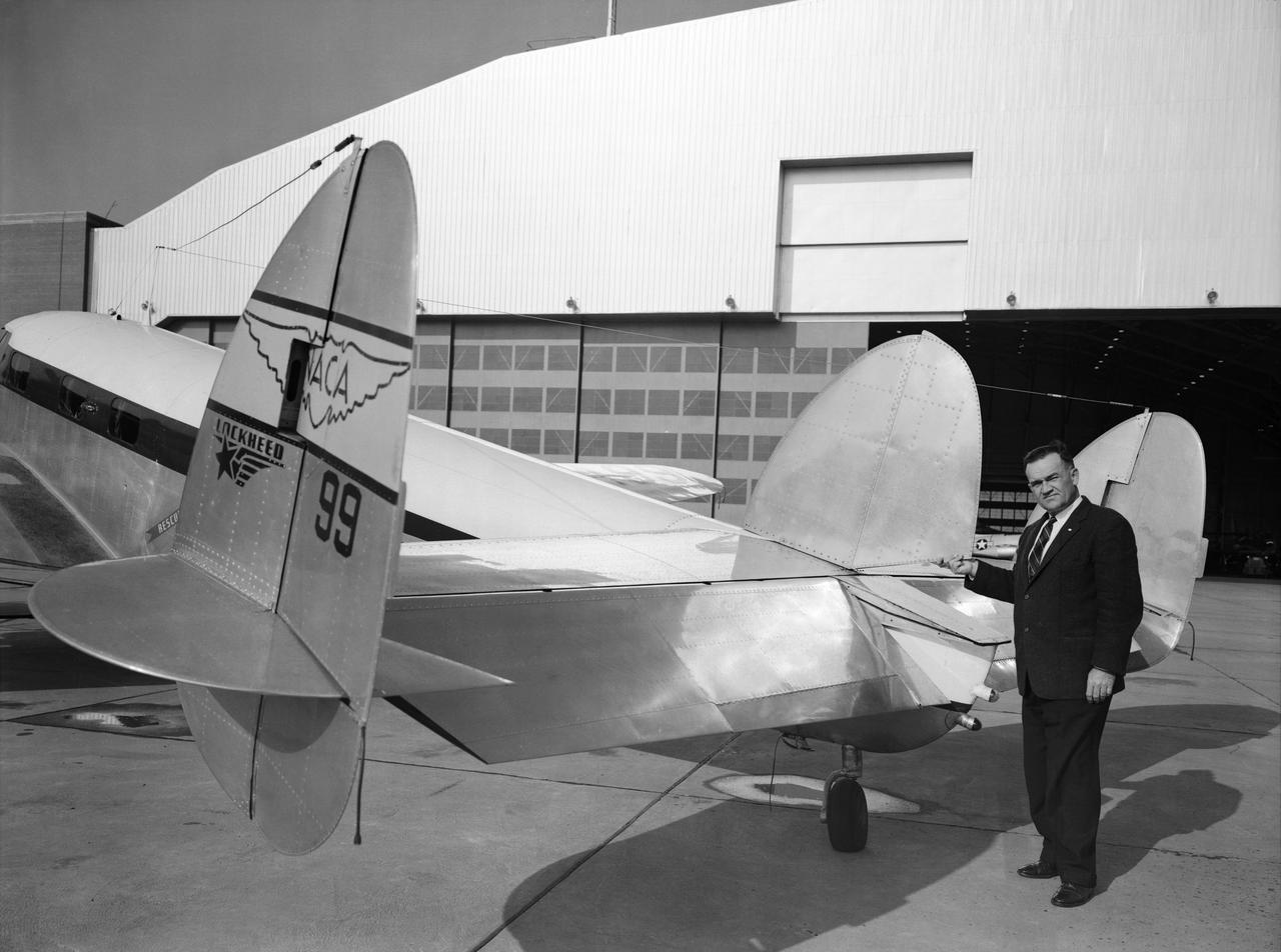 Melvin Gough at the Tail of a NACA Lockheed Plane