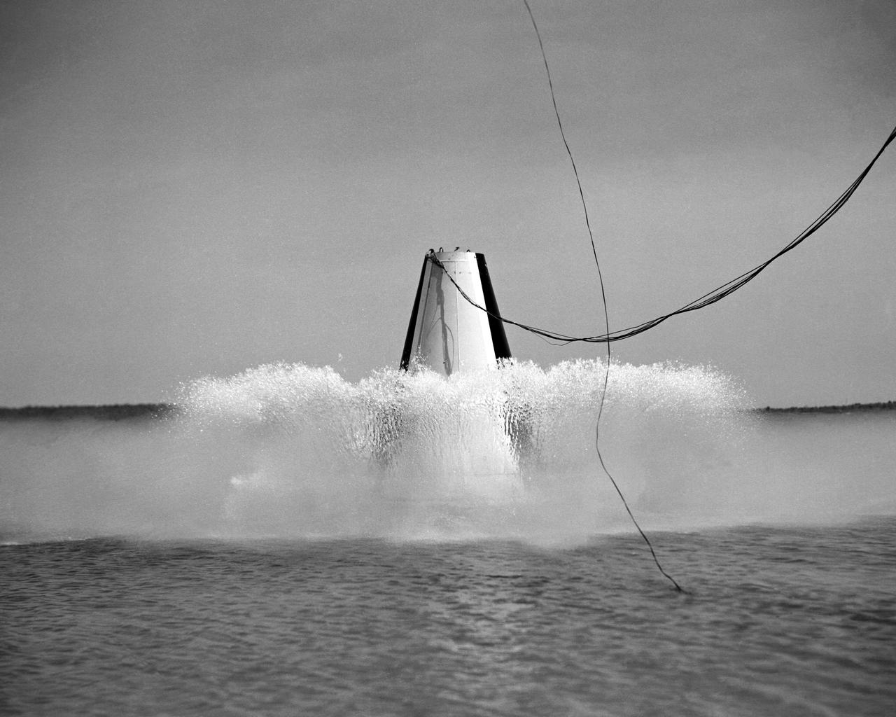  Photographed on: 08 05 1958. -- Impact test conducted by Langley's Hydrodynamics Division. The Division conducted a series of impact studies with full scale and model capsules of the original capsule shape A. Joseph Shortal wrote (Vol. 3, p. 16):  The basic design of the capsule was made by M.A. Faget and his coworkers at PARD during the winter of 1957-1958. It was natural, then, that extensive use was made of the facilities at Wallops during the development of the spacecraft. The tests at Wallops consisted of 26 full-size capsules, either launched from the ground by rocket power or dropped from airplanes at high altitude and 28 scaled models, either rocket boosted or released from balloons. Emphasis in the Wallops program was on dynamic stability and aerodynamic heating of the capsule, and effectiveness of the pilot-escape and parachute-recovery systems. The biggest part of the Wallops program was the series of full-size capsules, rocket launched with the Little Joe booster, developed especially for Mercury.  -- Published in Joseph A. Shortal, History of Wallops Station: Origins and Activities Through 1949, (Wallops Island, VA: National Aeronautics and Space Administration, Wallops Station, nd), Comment Edition.