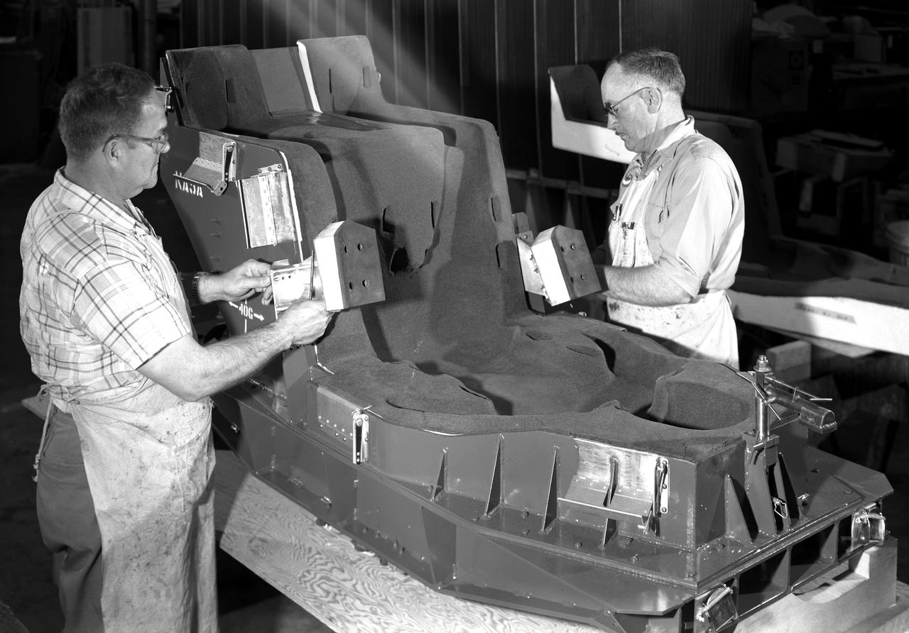 Space Couch Preparation. Man with the mustache is Richard H. Pingley 