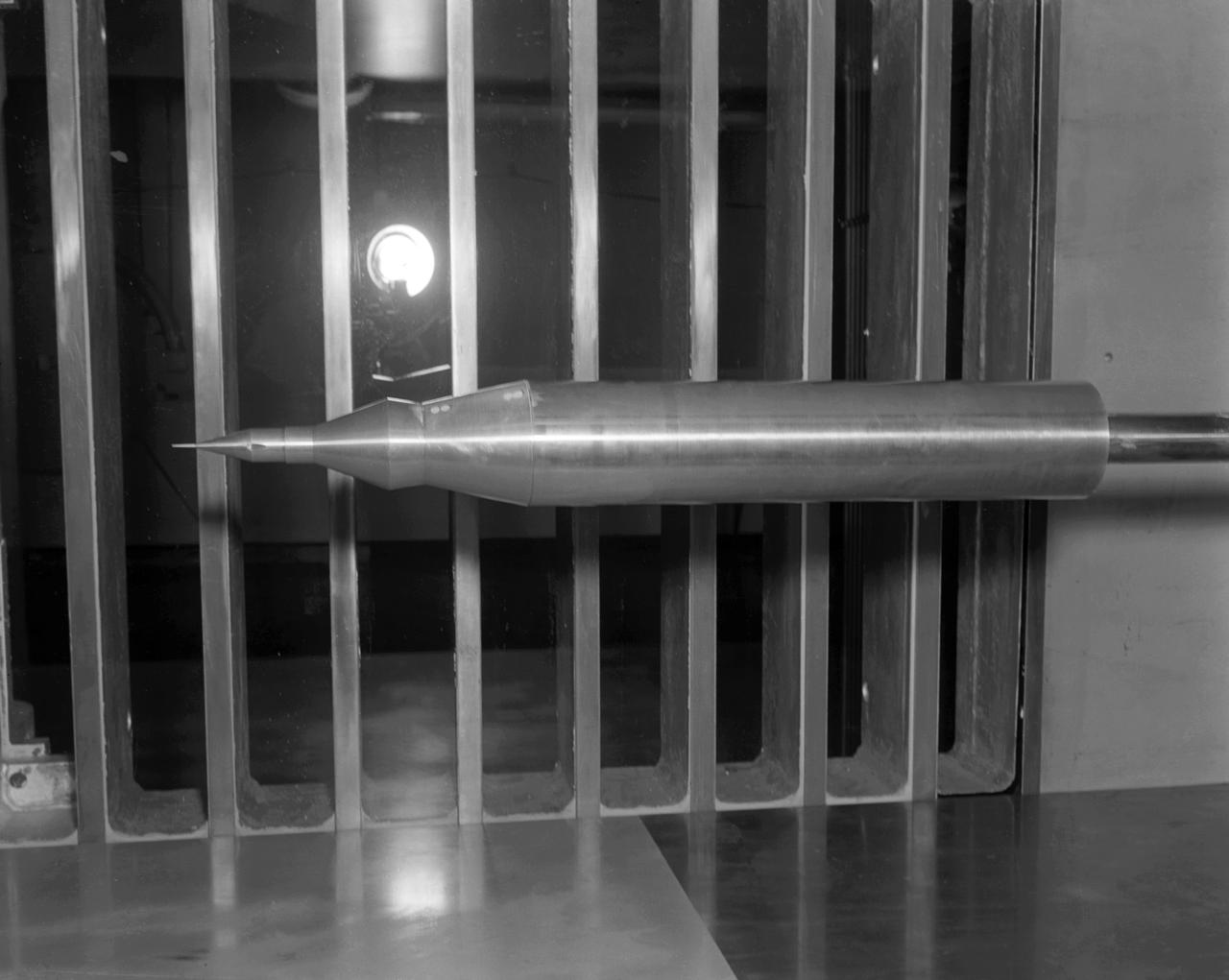 Model of Mercury (Redstone booster) carrying the spacecraft in the Unitary Plan wind tunnel for testing.