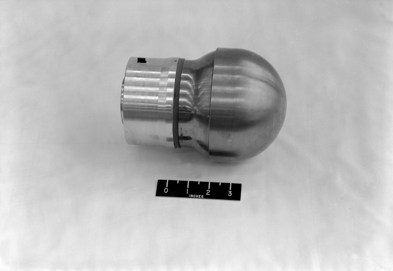 L59-8368 Spherical 5 Inch rocket motor with radio beacon mounted as a torus around the nozzle. View shows motor as used in trailblazer I vehicles. Photograph published in A New Dimension  Wallops Island Flight Test Range: The First Fifteen Years by Joseph Shortal. A NASA publication. Page 678.