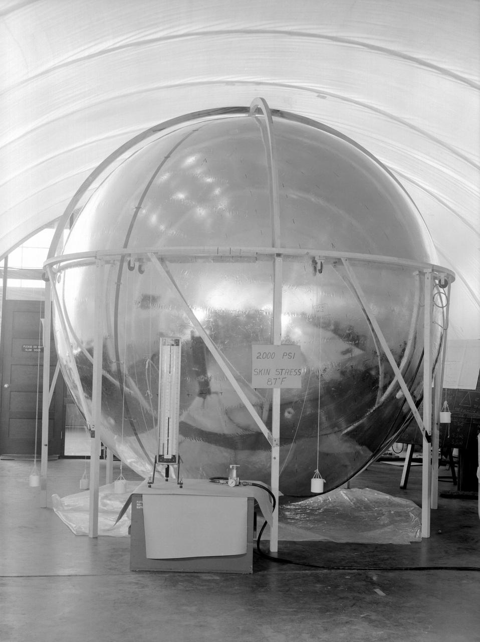 Photographed in 1960. -- Skin Stress Test of the 12-foot satellite built as a prototype of the full-scale Echo satellite. The 12-foot diameter of the sphere was chosen because that was the ceiling height in the Langley model shop. The proposal to build the 12-foot satellite was made in November 1957. -- Published in James R. Hansen, Spaceflight Revolution: NASA Langley Research Center From Sputnik to Apollo, NASA SP-4308, pp. 170-171.