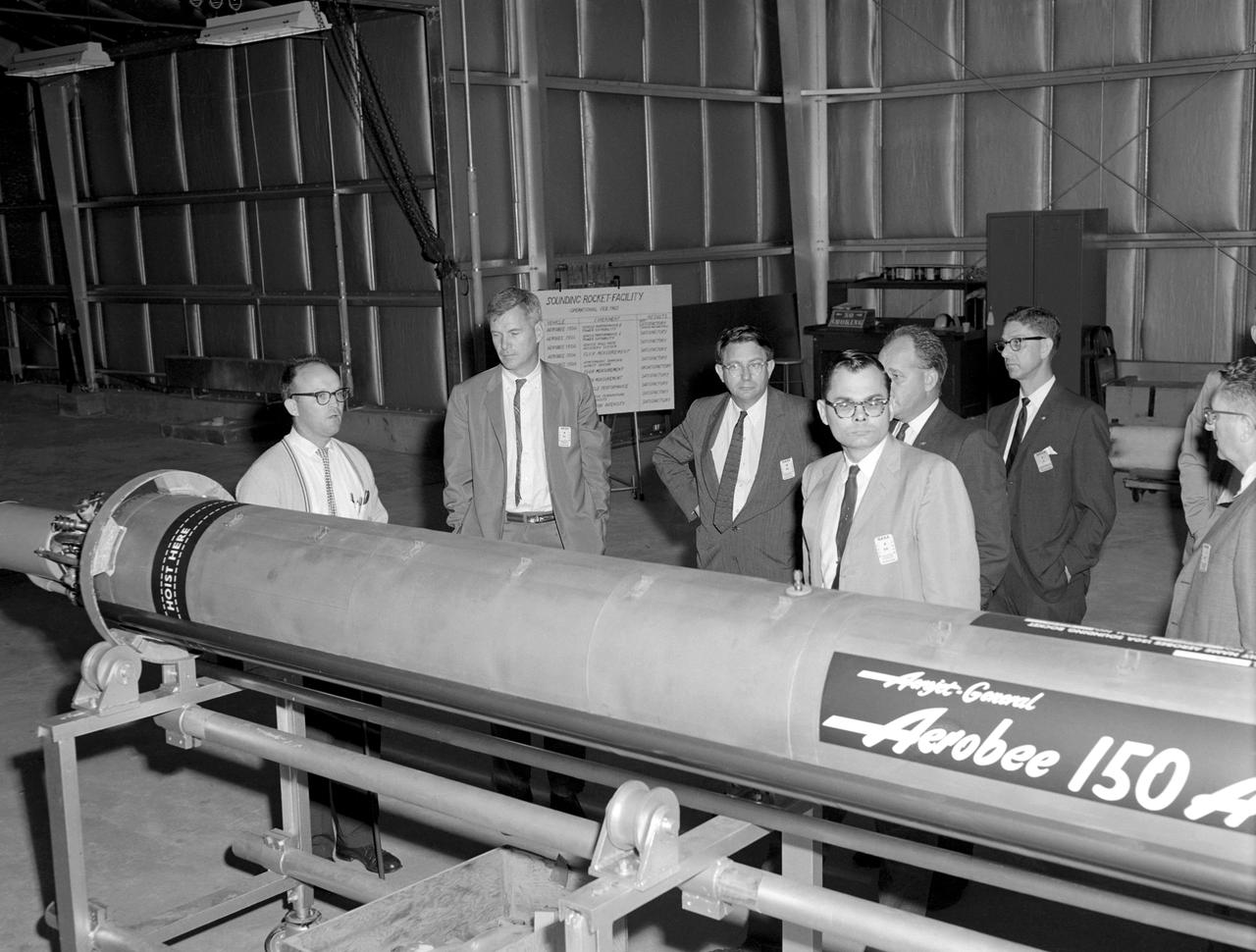 Photographed on 09/22/1960. -- An examination of the Aerojet-General "Aerobee 150A" propulsion system in February 1960. James Hansen described this as follows: "As for the technical definition of the rocket...the Langley engineers tried to keep developmental costs and time to a minimum by selecting components from off-the-shelf hardware. the majority of Scout's components were to come from an inventory of solid-fuel rockets produced for the military, although everyone involved understood that some improved motors would also have to be developed under contract. By early 1959, after intensive technical analysis and reviews, Langley settled on a design and finalized the selection of the major contractors. The rocket's 40-inch-diameter first stage was to be a new "Algol" motor, a combination of the Jupiter Senior and the navy Polaris produced by the Aerojet General Corporation, Sacramento, California. The 31-inch-diameter second stage, "Castor," was derived from the army's Sergeant and was to be manufactured by the Redstone Division of the Thiokol company in Huntsville, Alabama. the motor for the 30-inch-diameter third stage, "Antares," evolved under NASA contract from the ABL X248 design into a new version called the X254 (and subsequently into the X259); it was built under contract to NASA by ABL, a U.S. Navy Bureau of Ordnance facility operated by the Hercules Powder Company, Cumberland, Maryland. the final upper-stage propulsion unit, "Altair," which was 25.7 inches in diameter (34 inches at the heat shield), amounted to an improved edition of the X248 that was also manufactured by ABL." -- Published in James R. Hansen, Spaceflight Revolution: NASA Langley Research Center From Sputnik to Apollo, NASA SP-4308, pp.200-201.