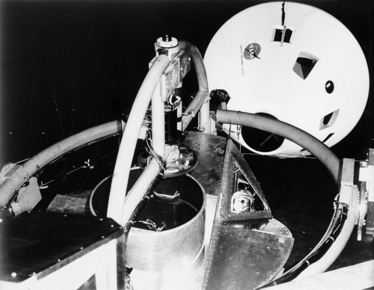 Originally the Rendezvous was used by the astronauts preparing for Gemini missions. The Rendezvous Docking Simulator was then modified and used to develop docking techniques for the Apollo program. "The LEM pilot's compartment, with overhead window and the docking ring (idealized since the pilot cannot see it during the maneuvers), is shown docked with the full-scale Apollo Command Module." A.W. Vogeley described the simulator as follows: "The Rendezvous Docking Simulator and also the Lunar Landing Research Facility are both rather large moving-base simulators. It should be noted, however, that neither was built primarily because of its motion characteristics. The main reason they were built was to provide a realistic visual scene. A secondary reason was that they would provide correct angular motion cues (important in control of vehicle short-period motions) even though the linear acceleration cues would be incorrect." -- Published in A.W. Vogeley, "Piloted Space-Flight Simulation at Langley Research Center," Paper presented at the American Society of Mechanical Engineers, 1966 Winter Meeting, New York, NY, November 27 - December 1, 1966;