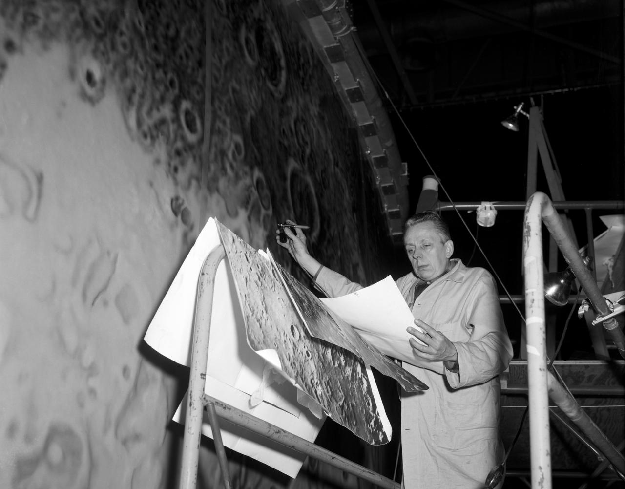 Artists used paintbrushes and airbrushes to recreate the lunar surface on each of the four models comprising the LOLA simulator. Project LOLA or Lunar Orbit and Landing Approach was a simulator built at Langley to study problems related to landing on the lunar surface. It was a complex project that cost nearly $2 million dollars. James Hansen wrote: "This simulator was designed to provide a pilot with a detailed visual encounter with the lunar surface; the machine consisted primarily of a cockpit, a closed-circuit TV system, and four large murals or scale models representing portions of the lunar surface as seen from various altitudes. The pilot in the cockpit moved along a track past these murals which would accustom him to the visual cues for controlling a spacecraft in the vicinity of the moon. Unfortunately, such a simulation--although great fun and quite aesthetic--was not helpful because flight in lunar orbit posed no special problems other than the rendezvous with the LEM, which the device did not simulate. Not long after the end of Apollo, the expensive machine was dismantled." (p. 379) Ellis J. White further described LOLA in his paper "Discussion of Three Typical Langley Research Center Simulation Programs," "Model 1 is a 20-foot-diameter sphere mounted on a rotating base and is scaled 1 in. = 9 miles. Models 2,3, and 4 are approximately 15x40 feet scaled sections of model 1. Model 4 is a scaled-up section of the Crater Alphonsus and the scale is 1 in. = 200 feet. All models are in full relief except the sphere." -- Published in James R. Hansen, Spaceflight Revolution, NASA SP-4308, p. 379; Ellis J. White, "Discussion of Three Typical Langley Research Center Simulation Programs," Paper presented at the Eastern Simulation Council (EAI's Princeton Computation Center), Princeton, NJ, October 20, 1966.