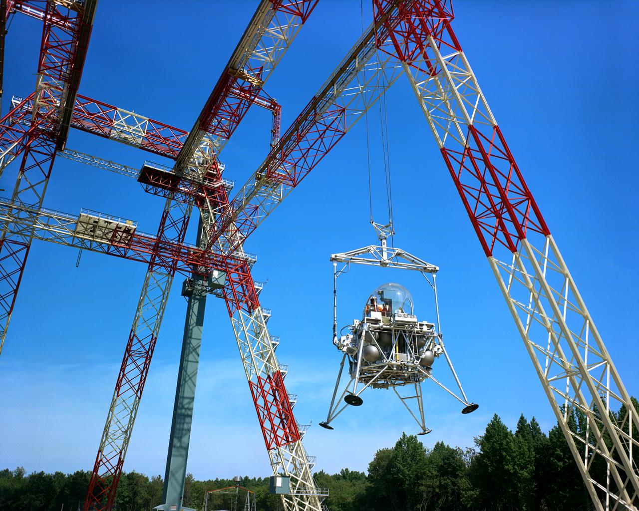 The Lunar Landing Research Facility at Langley Research Center has been put into operation. The facility, 250 feet high and 400 feet long, provides a controlled laboratory in which NASA scientists will work with research pilots to explore and develop techniques for landing a rocket-powered vehicle on the Moon, where the gravity is only one sixth as strong as on Earth. The Lunar Landing Research Facility, a controlled laboratory for exploring and developing techniques for landing a rocket-powered vehicle on the Moon, has been put into operation at the Langley Research Center. The $3.5 million facility includes a rocket-powered piloted flight test vehicle which is operated· while partially supported from a 250-foot high, 400-foot long gantry structure to simulate the one-sixth earth gravity of the Moon in research to obtain data on the problems of lunar landing. Excerpt from Langley Researcher July 2, 1965
