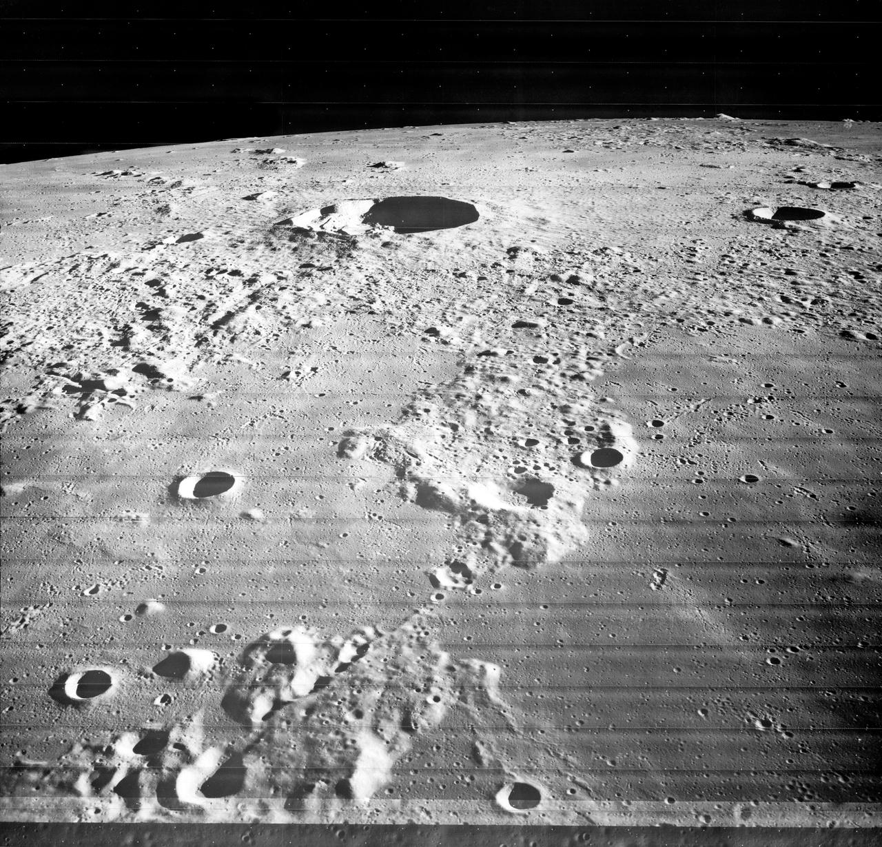 Small light colored area within the crater is Surveyor 1 on lunar surface photographed by  Lunar Orbiter III.  Published in the book "A Century at Langley" by Joseph Chambers. pg. 93 Moon Lunar Orbiter-Lunar Orbiter III: The hidden or dark side of the Moon was taken by Lunar Orbiter III During its mission to photograph potential lunar-landing sites for Apollo missions. -- Photograph published in Winds of Change, 75th Anniversary NASA publication (page 94), by James Schultz. Photo Number:67-H-328 is 1967-L-04026