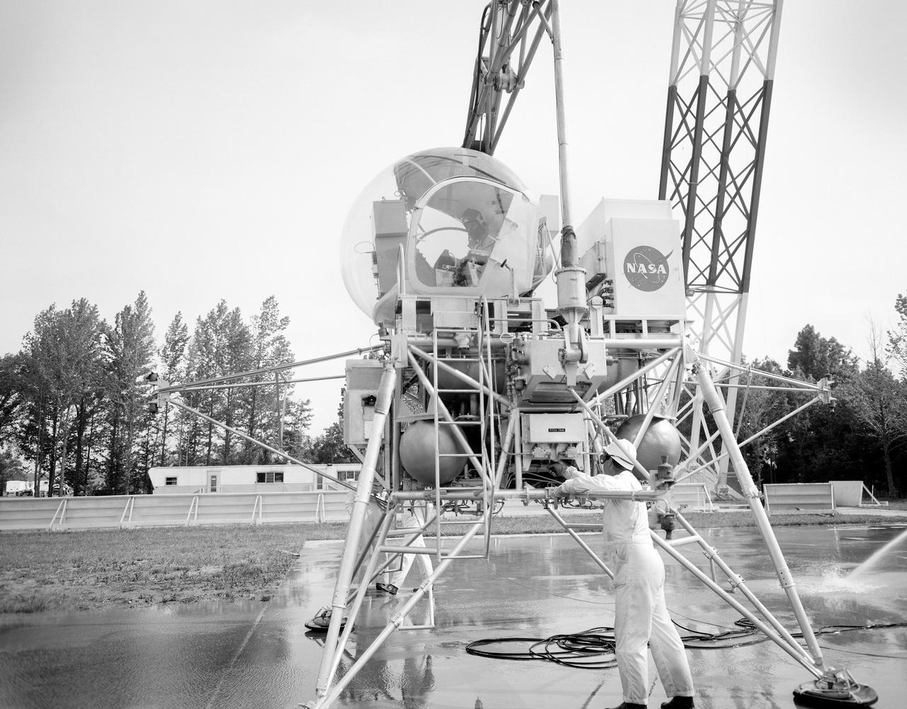 Astronaut Eugene Cernan at Lunar Lander Research Facility. Cernan under gantry, in training module.  Captain Cernan was one of fourteen astronauts selected by NASA in October 1963. On his second space flight, he was lunar module pilot of Apollo 10, May 18-26, 1969, the first comprehensive lunar-orbital qualification and verification flight test of an Apollo lunar module.