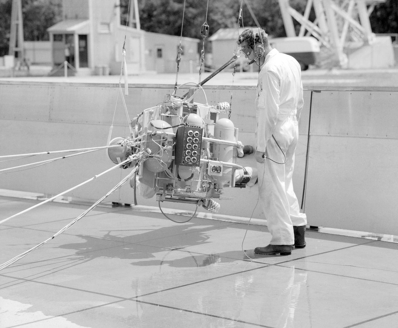 ICARUS - Lunar Walker with Pilot Dick Yenni.  Yenni in ICARUS rig for jet propelled lunar mobility, at Lunar Landing Research Facility or Gantry.