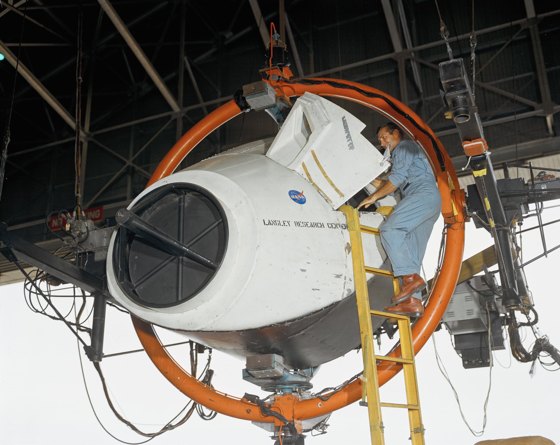 Richard F. Gordon Jr. climbing into training simulator at the Langley Research Center in Virginia. 