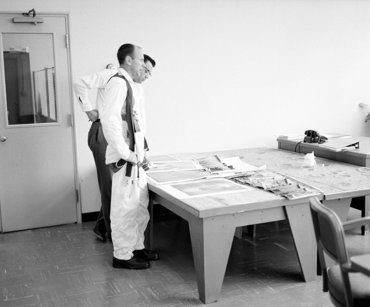 Astronauts Conrad and Bean at Lunar Landing Research Facility.  Alan Bean was one of the third group of astronauts named by NASA in October 1963. He served as backup astronaut for the Gemini 10 and Apollo 9 missions. In September of 1962, Mr. Conrad was selected as an astronaut by NASA. His first flight was Gemini V, which established the space endurance record and placed the United States in the lead for man-hours in space. As commander of Gemini XI, Mr. Conrad helped to set a world's altitude record. He then served as commander of Apollo XII, the second lunar landing. On Mr. Conrad's final mission, he served as commander of Skylab II, the first United States Space Station. https://www.nasa.gov/astronauts/biographies/former for more information.