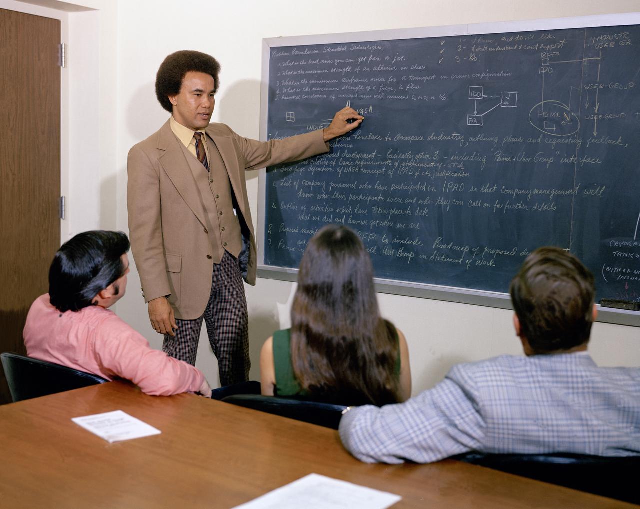 Minority Professionals at NASA Langley Research Center. Samuel J. Scott working in the Office of Director for Structures, Staff Assistant is at the board. 