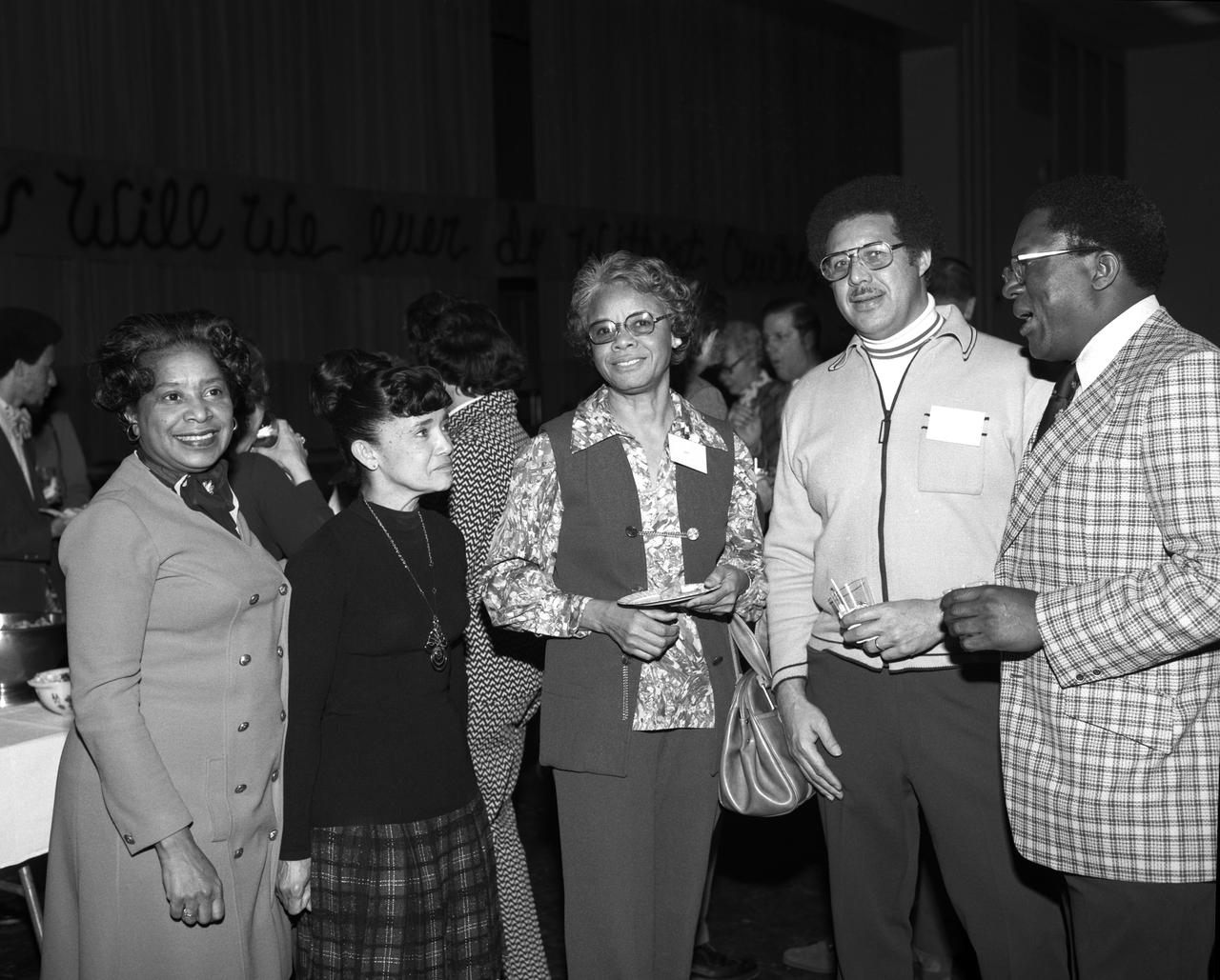 Photograph taken on February 5, 1975. Guests attending a retirement party for Vernon Courtney, of the MSD Communications Section. Mary Jackson standing on left with human computer Christine B. Richie next to her, another from the west computers group mentioned in the book "Hidden Figures" by author Margot Lee Shetterly. Mary Jackson from NASA Langley was NASA' s first African-American female engineer, and subsequent career supporting the hiring and promotion of other deserving female and minority employees.