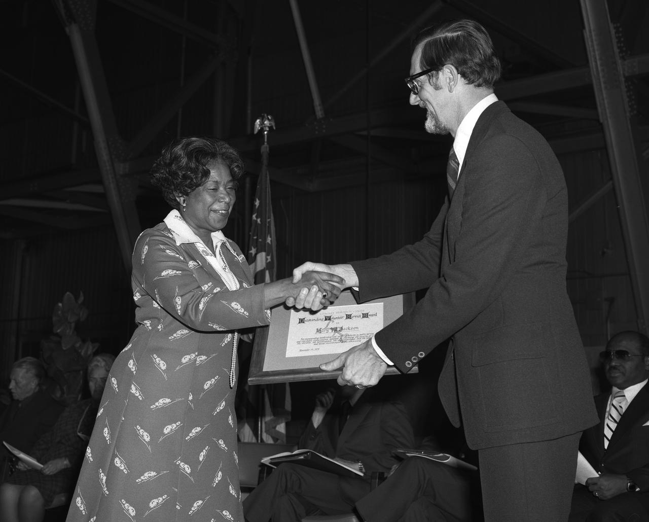 Langley Center Director Donald P. Hearth (right) presenting Mary Jackson with Outstanding Volunteer Service Award.  Mary Jackson was NASA's first African-American female engineer,and subsequent career supporting the hiring and promotion of other deserving female and minority employees. 