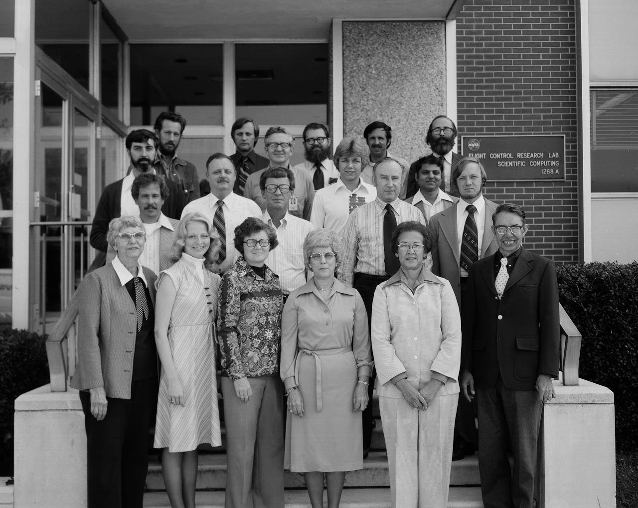 FDCD Stability and Control Branch Photo.   Names, rows front to back, people left to right: Ground level: 1. Margery Hanna 2. Debra L. Livingston 3. Carolyn Grantham 4. Nell Moore 5. Katherine G. Johnson 6. Hewitt Phillips Step 1: 1. John Shaughnessy 2. John Young 3. Bill Martz 4. Charles T. Woolley  Step 2: 1. Al Hamer 2. Marion Wise (?) 3. Suresh Joshi Step 3: 1. Willard W. Anderson 2. Albert A. Schy 3. Daniel P. Giesy Step 4: 1. Hugh Bergeron 2. Claude Keckler 3. Nelson Groom  4. Ralph Will Names Given by Danial Pl. Giesy. 