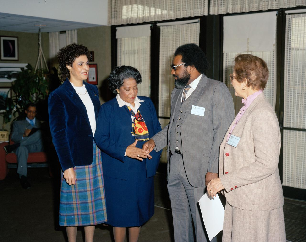 Photograph taken November 8,1984.  Student Symposium Meeting Left to right Vivian Merritt, Office of Equal Opportunity Programs, Mary Jackson, Manger, Federal Woman’s Program, guest speaker Mr. James Jennings, and Katherine Johnson, Flight Dynamics and Control Division.   Jennings’ career has included management and analyst positions at the Marshall Space Flight Center and NASA Headquarters. He is known for his ability to work with people and get things done. Jennings is a member of numerous professional and community organizations. He has served as Chairman of the KSC Combined Federal Campaign and Savings Bond Drive. Jennings has received numerous awards during his NASA career including an Equal Employment Opportunity Award in 1975, an Exceptional Service Medal in 1988, the Equal Employment Opportunity Medal in 1989, and an Outstanding Leadership Medal in 1994. Jennings also received the Distinguished Service Award in 1989 and the President's Award in 1999 from the Space Coast Chapter of the Federally Employed Women. He was conferred the rank of Meritorious Executive in 1997, and received the 1999 Presidential Distinguished Rank Award.