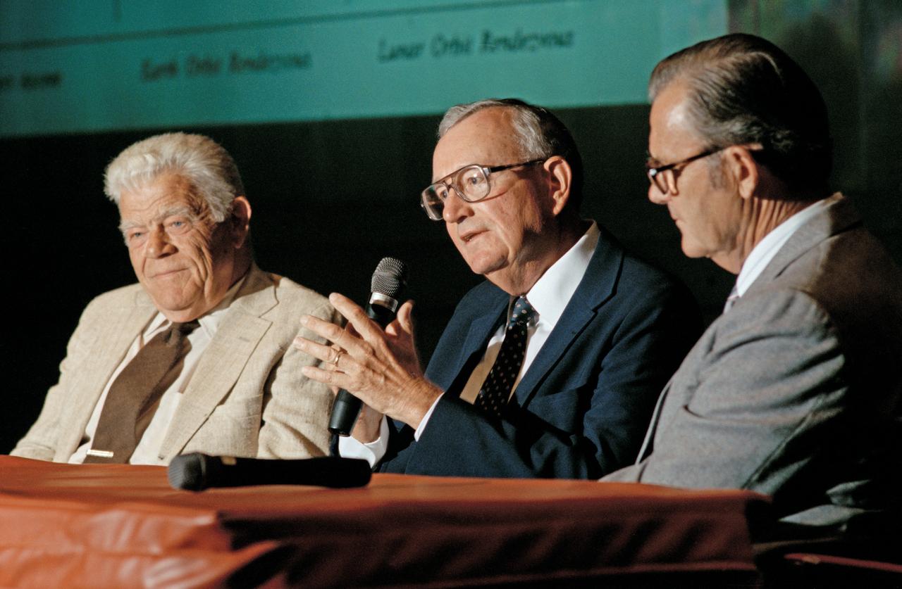 20th Anniversary of the First Lunar Landing Colloquium held at Langley.  William H. Michael Jr. (center) reviews the evolution of his parking orbit concept with Clinton E. Brown (right) head of the Lunar Exploration Working Group and Arthur Vogeley (left) mastermind of Langley's rendezvous and docking simulators of the 1960's. 