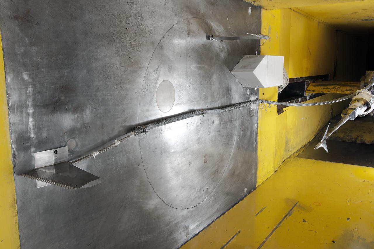 UPWT Test 1998 Continuous Data Sonic Boom Test. Sonic Boom Hardward Mounted in the Langley Unitary Plan wind Tunnel(UPWT). Conical survey probes, wedge probe, and wind tunnel wall boundary layer rake. Rectangular box with wedge front end is a transducer box to that held pressure transducer for the conical probes.