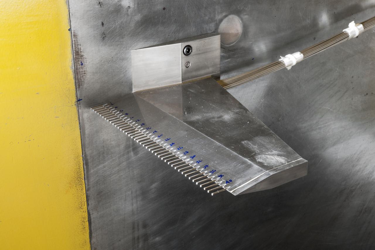 UPWT Test 1998 Continuous Data Sonic Boom Test. Sonic Boom Hardward Mounted in the Langley Unitary Plan wind Tunnel(UPWT). Conical survey probes, wedge probe, and wind tunnel wall boundary layer rake. Rectangular box with wedge front end is a transducer box to that held pressure transducer for the conical probes.