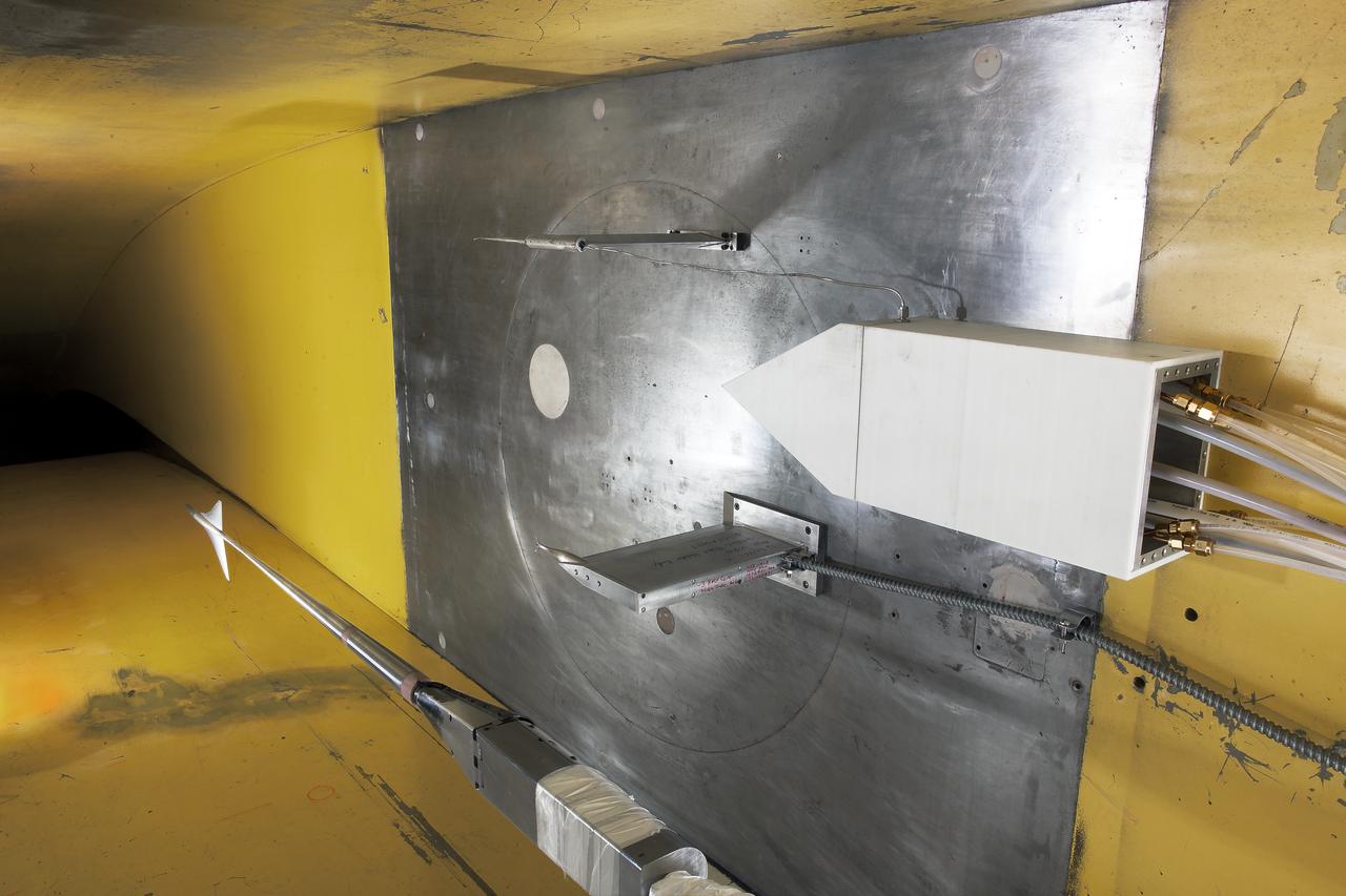 UPWT Test 1998 Continuous Data Sonic Boom Test. Sonic Boom Hardward Mounted in the Langley Unitary Plan wind Tunnel(UPWT). Conical survey probes, wedge probe, and wind tunnel wall boundary layer rake. Rectangular box with wedge front end is a transducer box to that held pressure transducer for the conical probes.