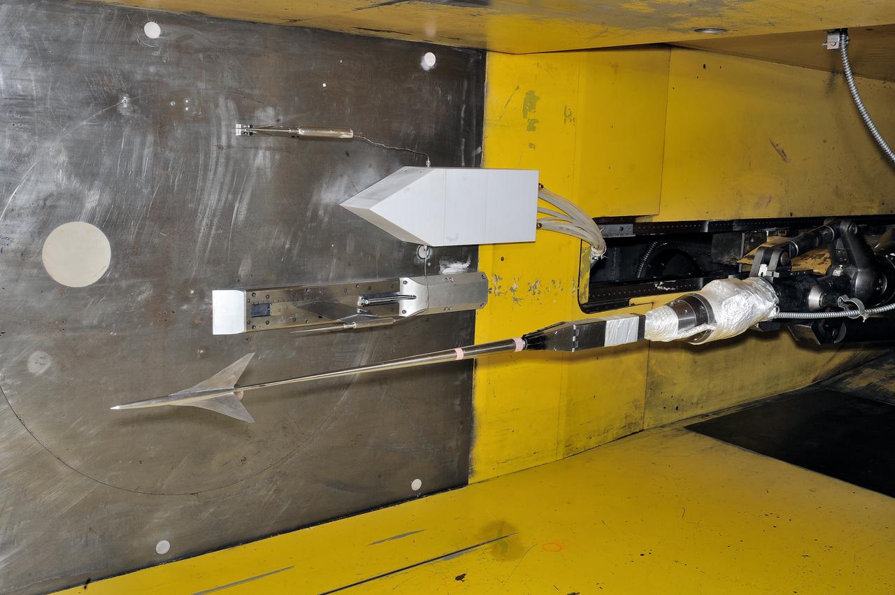 UPWT Test 1998 Continuous Data Sonic Boom Test. Sonic Boom Hardward Mounted in the Langley Unitary Plan wind Tunnel(UPWT). Conical survey probes, wedge probe, and wind tunnel wall boundary layer rake. Rectangular box with wedge front end is a transducer box to that held pressure transducer for the conical probes.