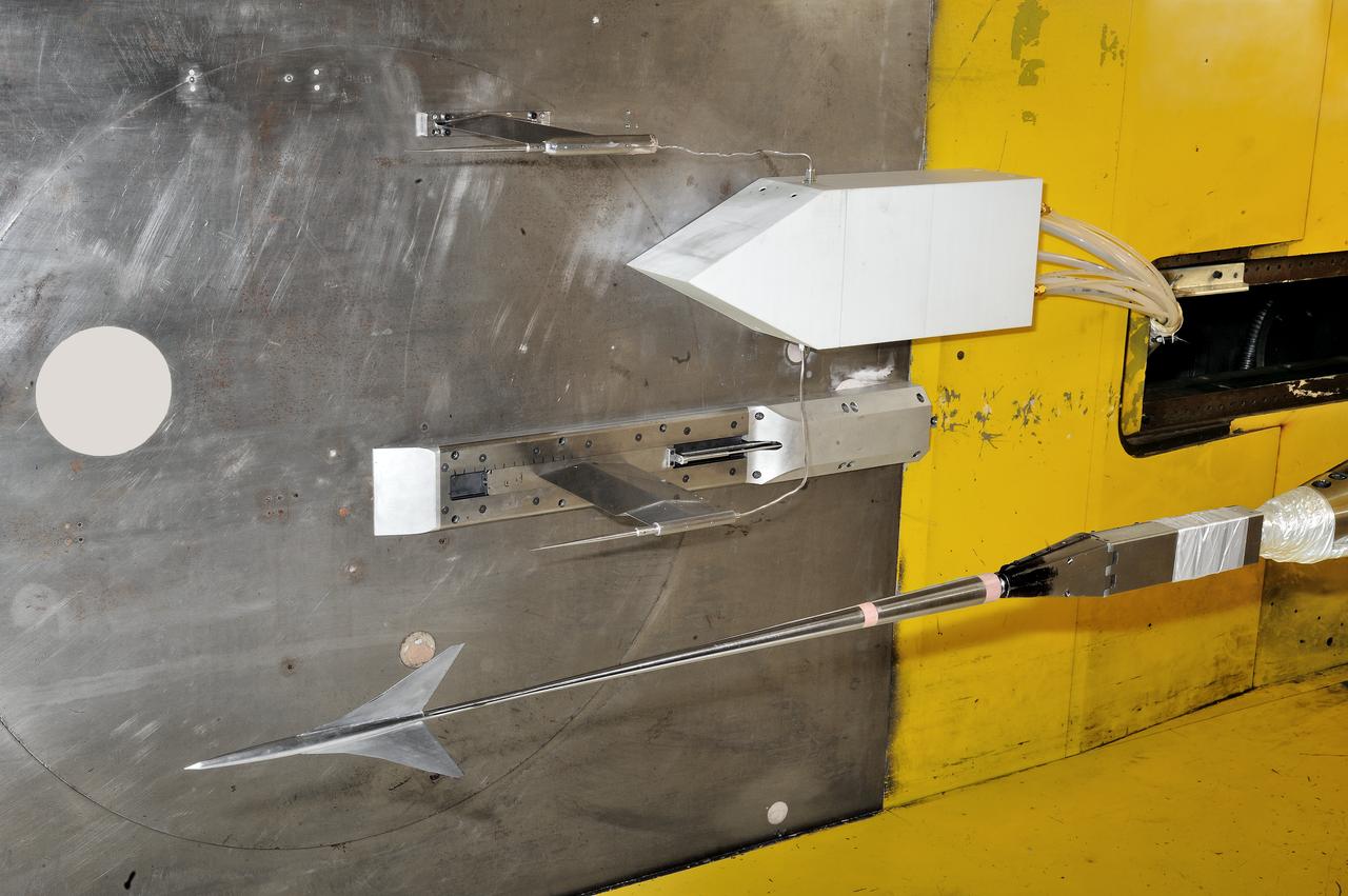 UPWT Test 1998 Continuous Data Sonic Boom Test. Sonic Boom Hardward Mounted in the Langley Unitary Plan wind Tunnel(UPWT). Conical survey probes, wedge probe, and wind tunnel wall boundary layer rake. Rectangular box with wedge front end is a transducer box to that held pressure transducer for the conical probes.