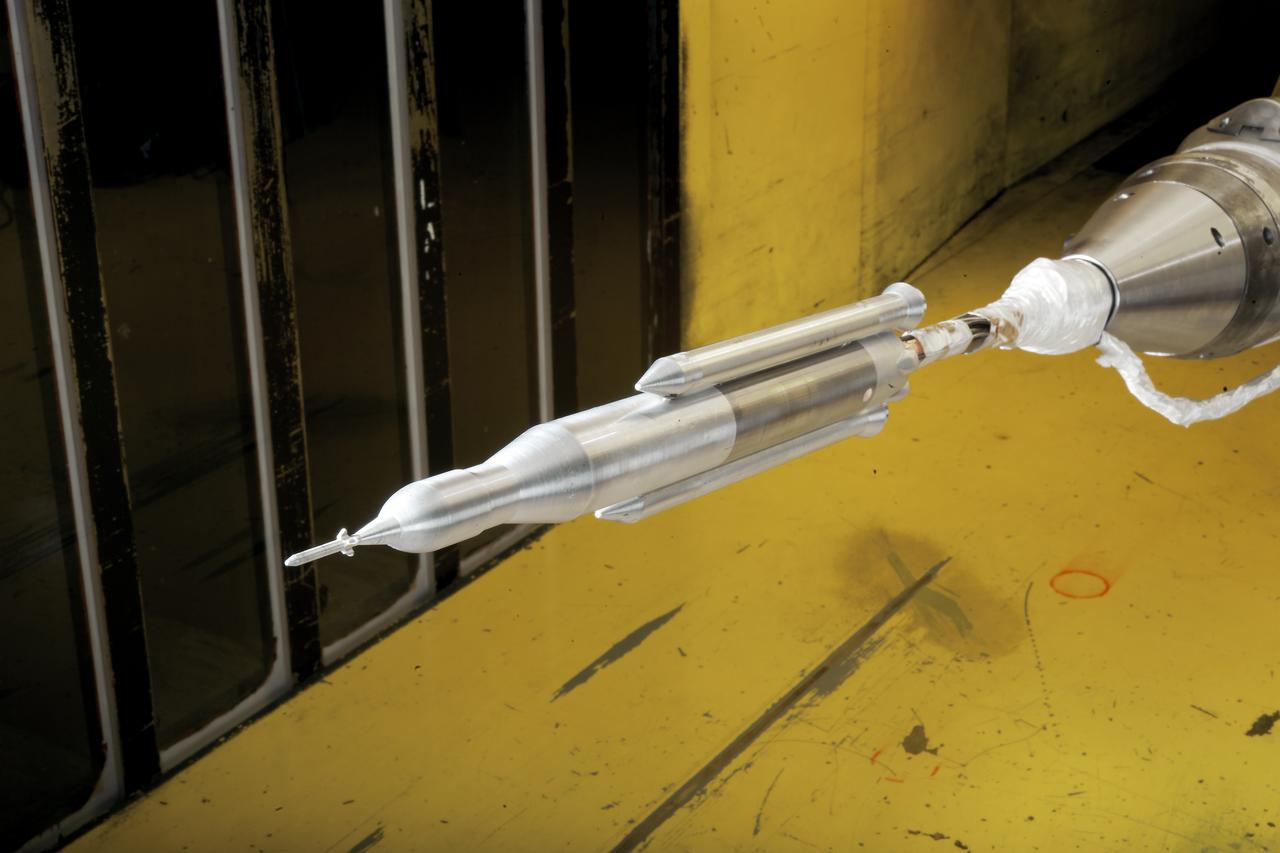 0.4 Percent Scale Space Launch System Wind Tunnel Test  0.4 Percent Scale SLS model installed in the NASA Langley Research Center Unitary Plan Wind Tunnel Test Section 1 for aerodynamic force and movement testing.