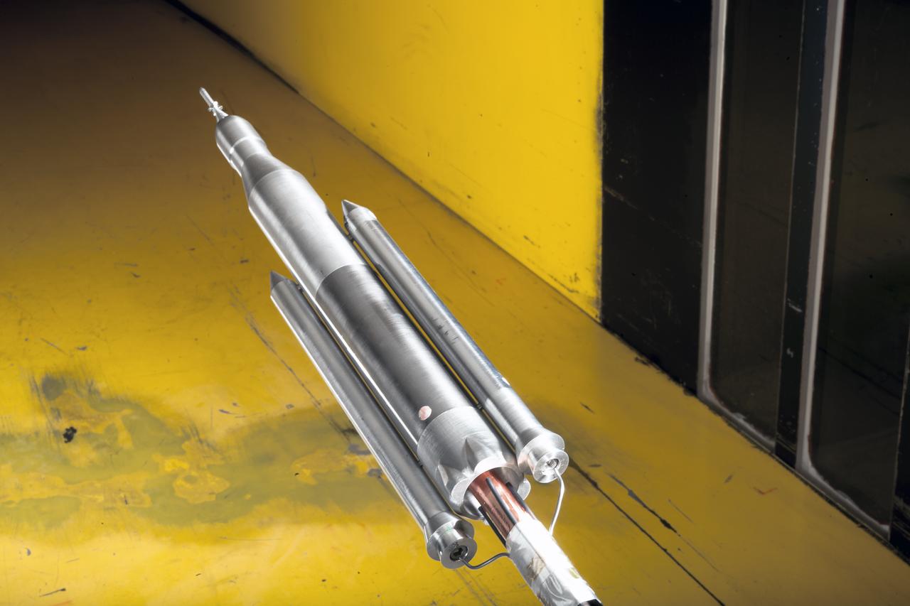 0.4 Percent Scale Space Launch System Wind Tunnel Test  0.4 Percent Scale SLS model installed in the NASA Langley Research Center Unitary Plan Wind Tunnel Test Section 1 for aerodynamic force and movement testing.