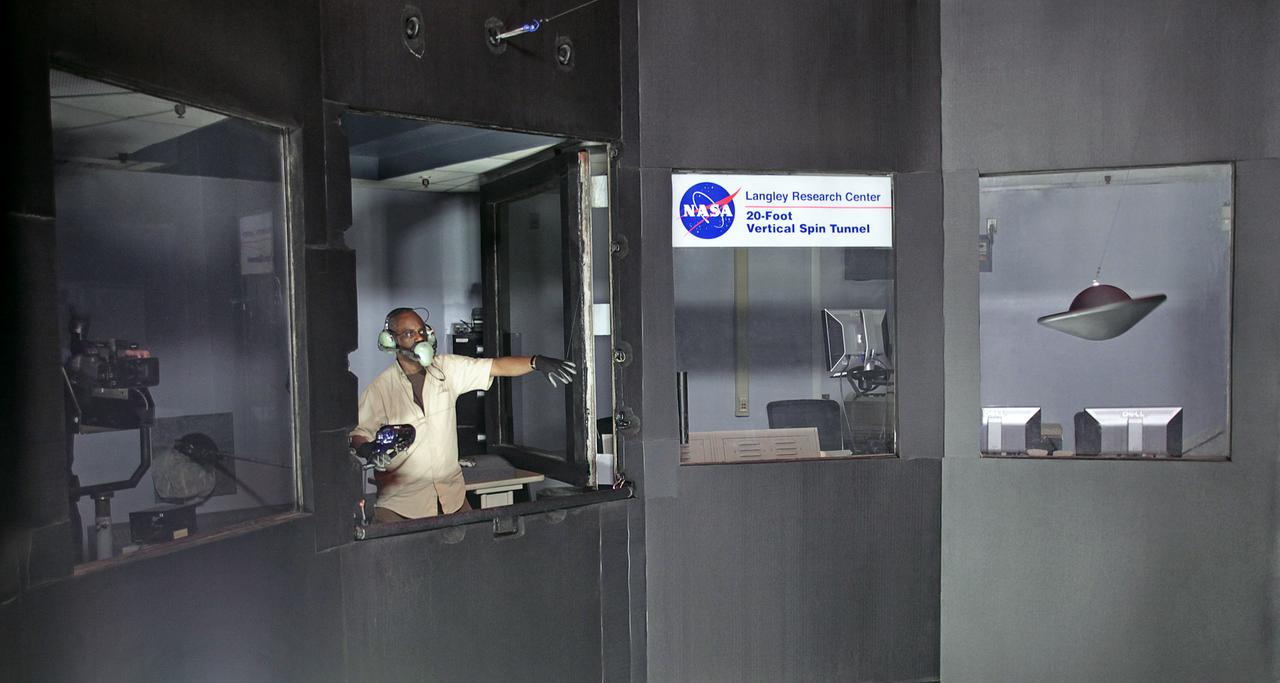 NASA Langley engineer, Clinton Duncan maintains controls of the tethered Multi Mission Earth Entry Vehicle model while being tested in the Vertical Spin Tunnel. 