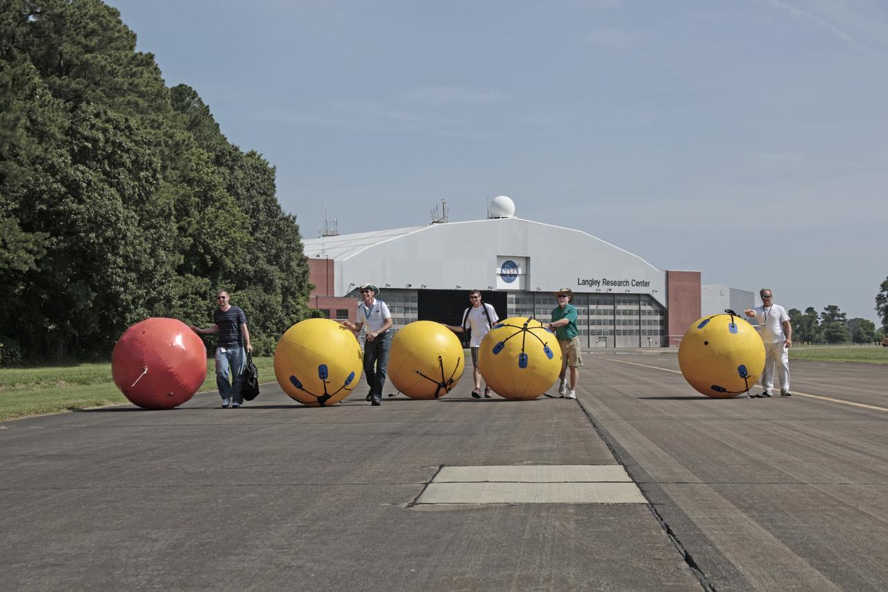 Engineers and technicians from NASA Langley Research Center in Virginia, Kennedy Space Center in Florida and Lockheed Martin in Colorado conduct a fit check on the Orion Crew Module at NASA Langley