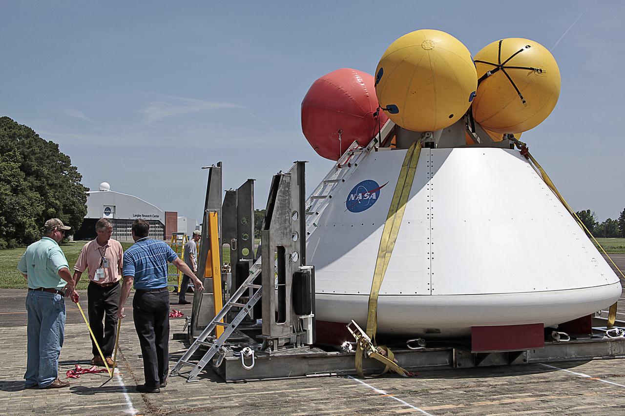 Engineers and technicians from NASA Langley Research Center in Virginia, Kennedy Space Center in Florida and Lockheed Martin in Colorado conduct a fit check on the Orion Crew Module at NASA Langley