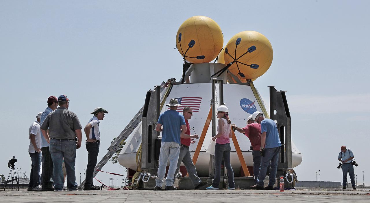 Engineers and technicians from NASA Langley Research Center in Virginia, Kennedy Space Center in Florida and Lockheed Martin in Colorado conduct a fit check on the Orion Crew Module at NASA Langley