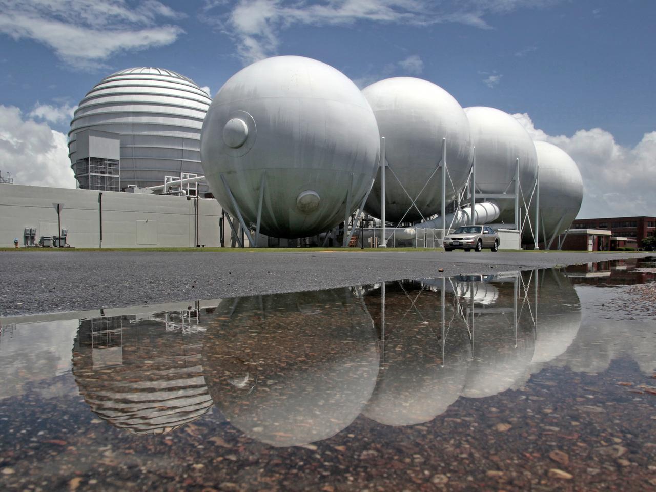 The vacuum spheres outside of building 1247 are reflected in a pool of rain water after an unusual break in weather on Friday, which gave a brief moment of sunshine, blue skies and standing water as Tropical Storm Andrea approaches from the south.