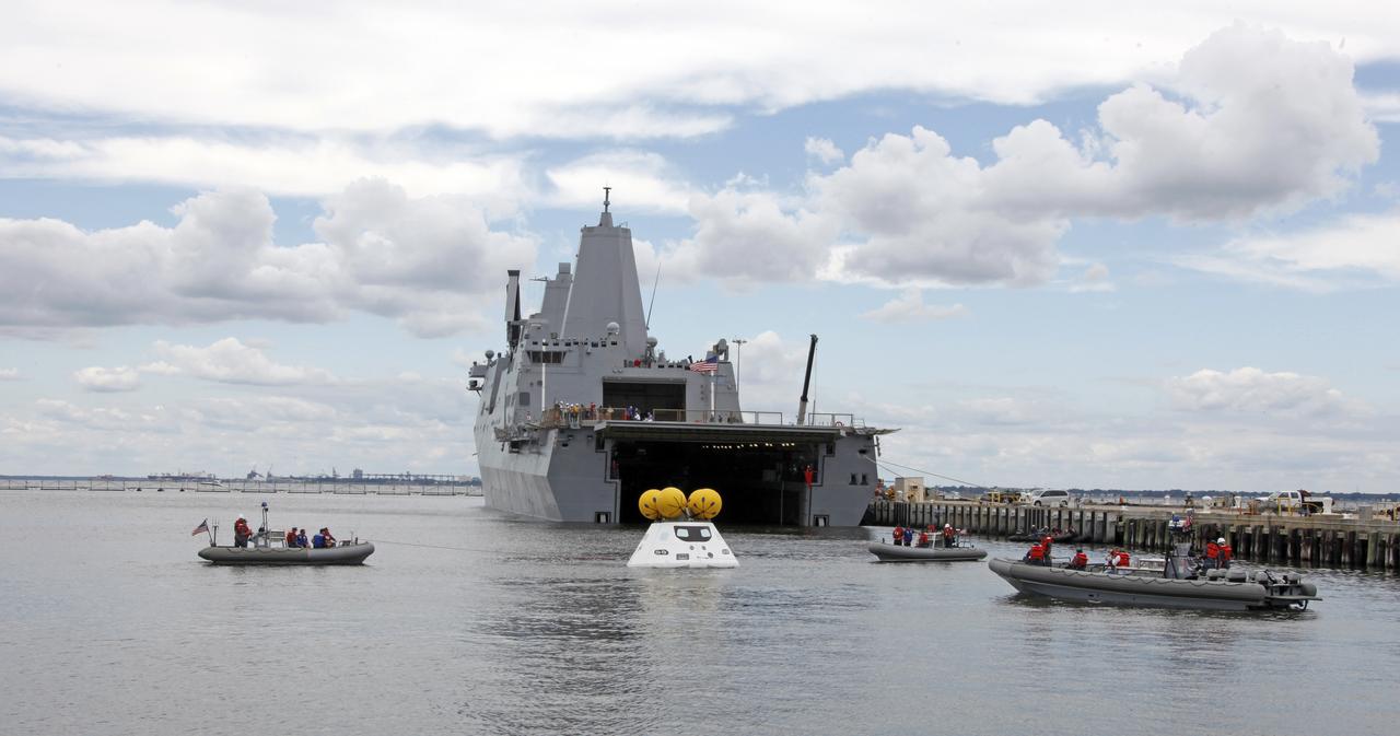 On August 15, 2013, at the Naval Station Norfolk near NASA’s Langley Research Center in Virginia, NASA and the U.S. Navy conducted a stationary recovery test on the Orion boilerplate test article in the water near a U.S. Navy ship. NASA and the U.S. Navy are conducting tests to prepare for recovery of the Orion crew module and forward bay cover on its return from a deep space mission. The stationary recovery tests allow the teams to demonstrate and evaluate the recovery processes, the hardware and the test personnel in a controlled environment. During the test, the U.S Navy Dive Team checked the capsule for hazards while sailors from the USS Arlington approached the capsule in inflatable boats, and towed it back to the ship’s flooded well deck. A second test will be conducted next year in the open waters of the Pacific Ocean.