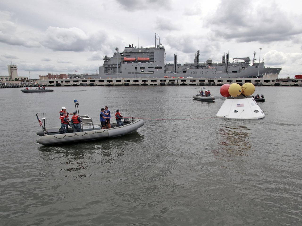 On August 15, 2013, at the Naval Station Norfolk near NASA’s Langley Research Center in Virginia, NASA and the U.S. Navy conducted a stationary recovery test on the Orion boilerplate test article in the water near a U.S. Navy ship. NASA and the U.S. Navy are conducting tests to prepare for recovery of the Orion crew module and forward bay cover on its return from a deep space mission. The stationary recovery tests allow the teams to demonstrate and evaluate the recovery processes, the hardware and the test personnel in a controlled environment. During the test, the U.S Navy Dive Team checked the capsule for hazards while sailors from the USS Arlington approached the capsule in inflatable boats, and towed it back to the ship’s flooded well deck. A second test will be conducted next year in the open waters of the Pacific Ocean.