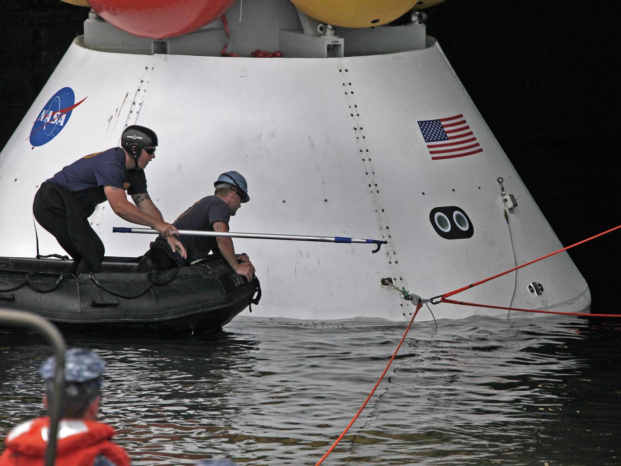 On August 15, 2013, at the Naval Station Norfolk near NASA’s Langley Research Center in Virginia, NASA and the U.S. Navy conducted a stationary recovery test on the Orion boilerplate test article in the water near a U.S. Navy ship. NASA and the U.S. Navy are conducting tests to prepare for recovery of the Orion crew module and forward bay cover on its return from a deep space mission. The stationary recovery tests allow the teams to demonstrate and evaluate the recovery processes, the hardware and the test personnel in a controlled environment. During the test, the U.S Navy Dive Team checked the capsule for hazards while sailors from the USS Arlington approached the capsule in inflatable boats, and towed it back to the ship’s flooded well deck. A second test will be conducted next year in the open waters of the Pacific Ocean.