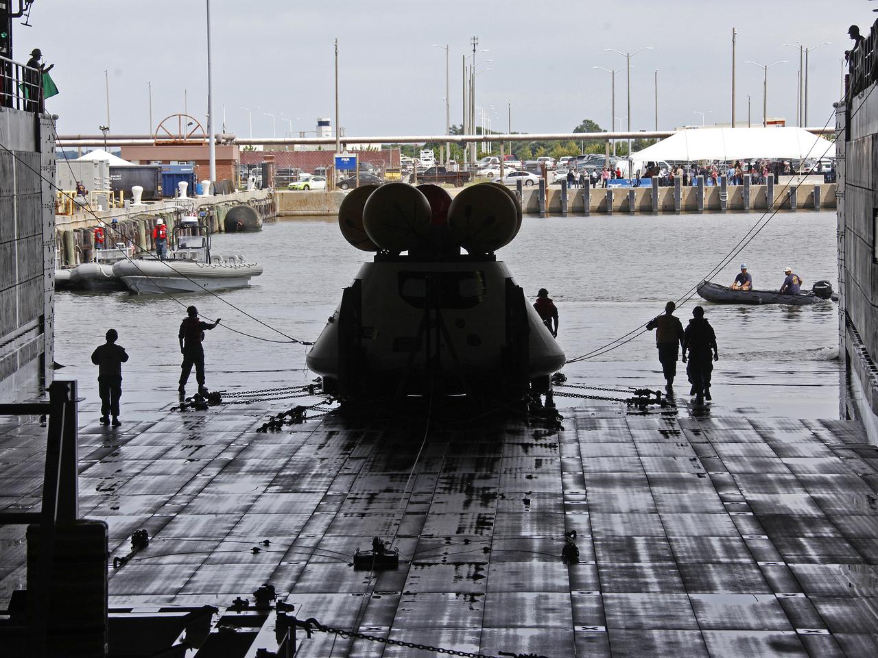 On August 15, 2013, at the Naval Station Norfolk near NASA’s Langley Research Center in Virginia, NASA and the U.S. Navy conducted a stationary recovery test on the Orion boilerplate test article in the water near a U.S. Navy ship. NASA and the U.S. Navy are conducting tests to prepare for recovery of the Orion crew module and forward bay cover on its return from a deep space mission. The stationary recovery tests allow the teams to demonstrate and evaluate the recovery processes, the hardware and the test personnel in a controlled environment. During the test, the U.S Navy Dive Team checked the capsule for hazards while sailors from the USS Arlington approached the capsule in inflatable boats, and towed it back to the ship’s flooded well deck. A second test will be conducted next year in the open waters of the Pacific Ocean.
