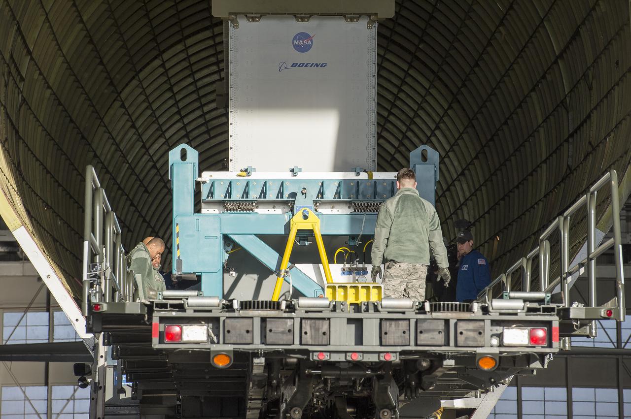 Super Guppy arrival and (MBB) Multi-Bay Box Delivery ; Super Guppy arrival and MBB Delivery: super Guppy arrival at NASA Langley hangar, and unloading of (MBB) multi-bay box, transport of MBB to COLTS and move into building 1256. 