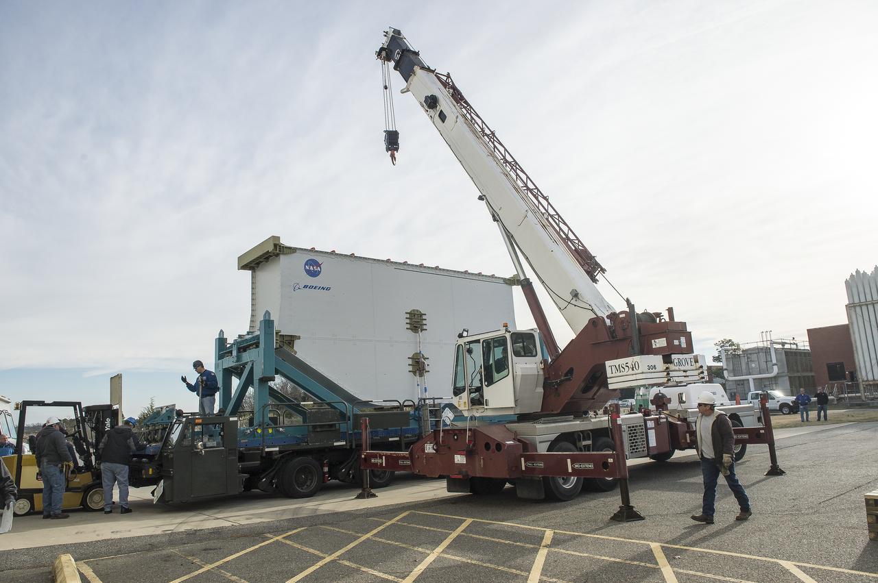 Super Guppy arrival and (MBB) Multi-Bay Box Delivery ; Super Guppy arrival and MBB Delivery: super Guppy arrival at NASA Langley hangar, and unloading of (MBB) multi-bay box, transport of MBB to COLTS and move into building 1256. 