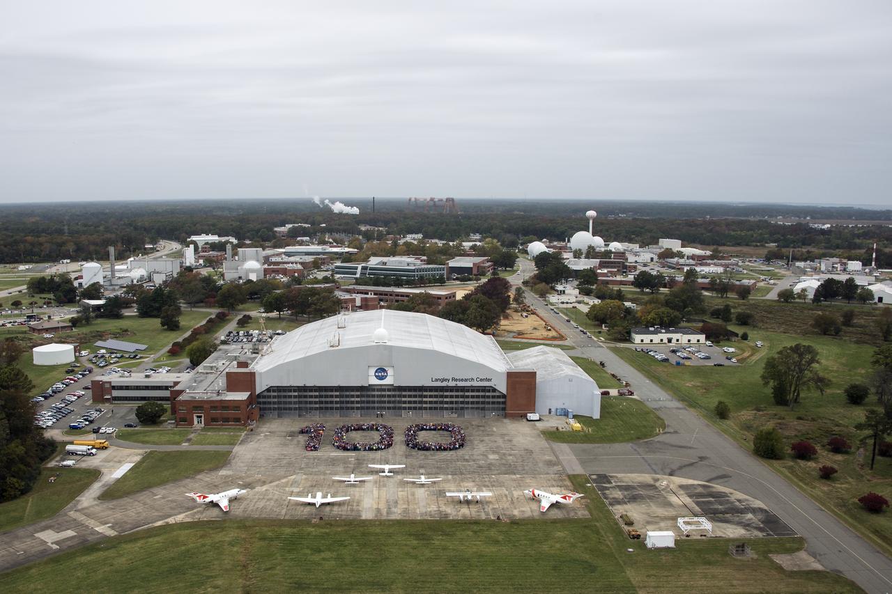 Aerial photos of NASA Langley employees gathered on the back ramp in the shape of 100.