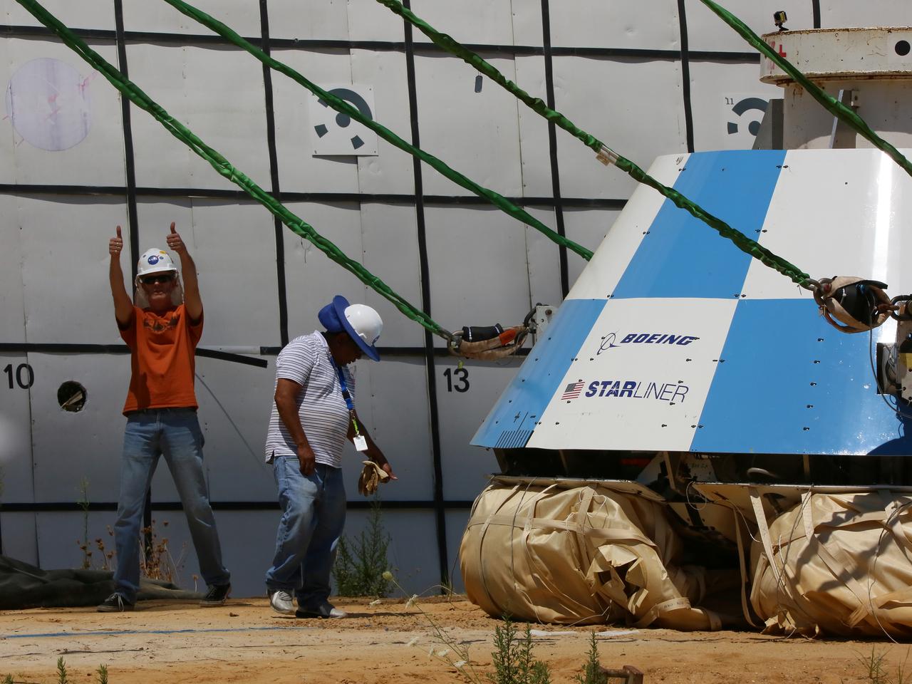 "Thumbs up" is signaled by ground personnel at NASA’s Langley Research Center in Hampton, Virginia, after a mock-up of the Boeing CST-100 Starliner spacecraft completed a land landing qualification test. The operation was to simulate what the actual spacecraft and crew members may experience while returning to Earth from space. The Starliner is being developed in collaboration with NASA’s Commercial Crew Program. Along with SpaceX’s Crew Dragon, the spacecraft is part of the agency’s effort to return America’s capability to launch astronauts from the agency's Kennedy Space Center in Florida to the International Space Station.