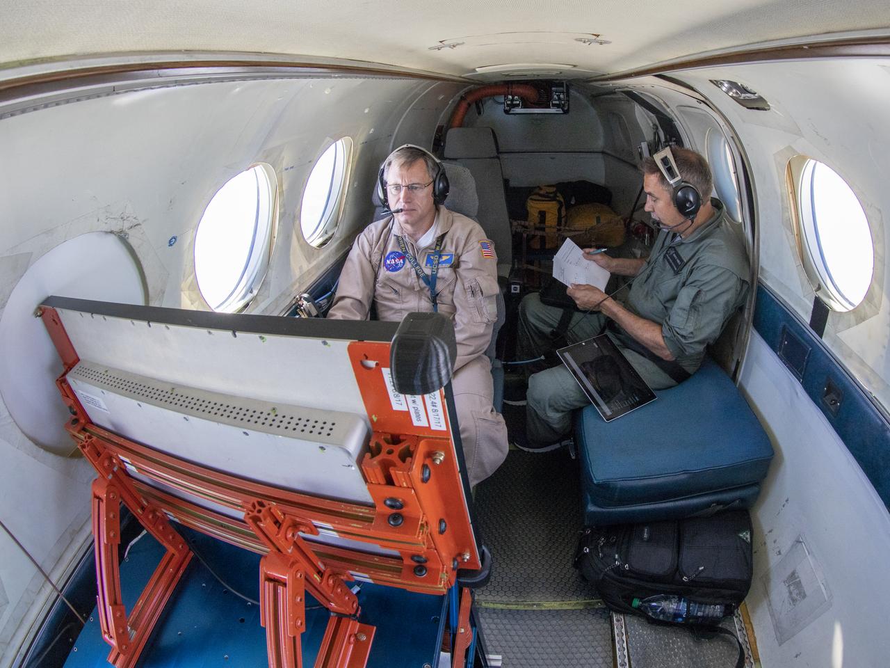 Testing the External Vision System (XVS) software on the B200 King Air. Pilots, Peter Coen and Wayne Ringelberg attempt to spot an incoming aircraft on the XVS monitor.