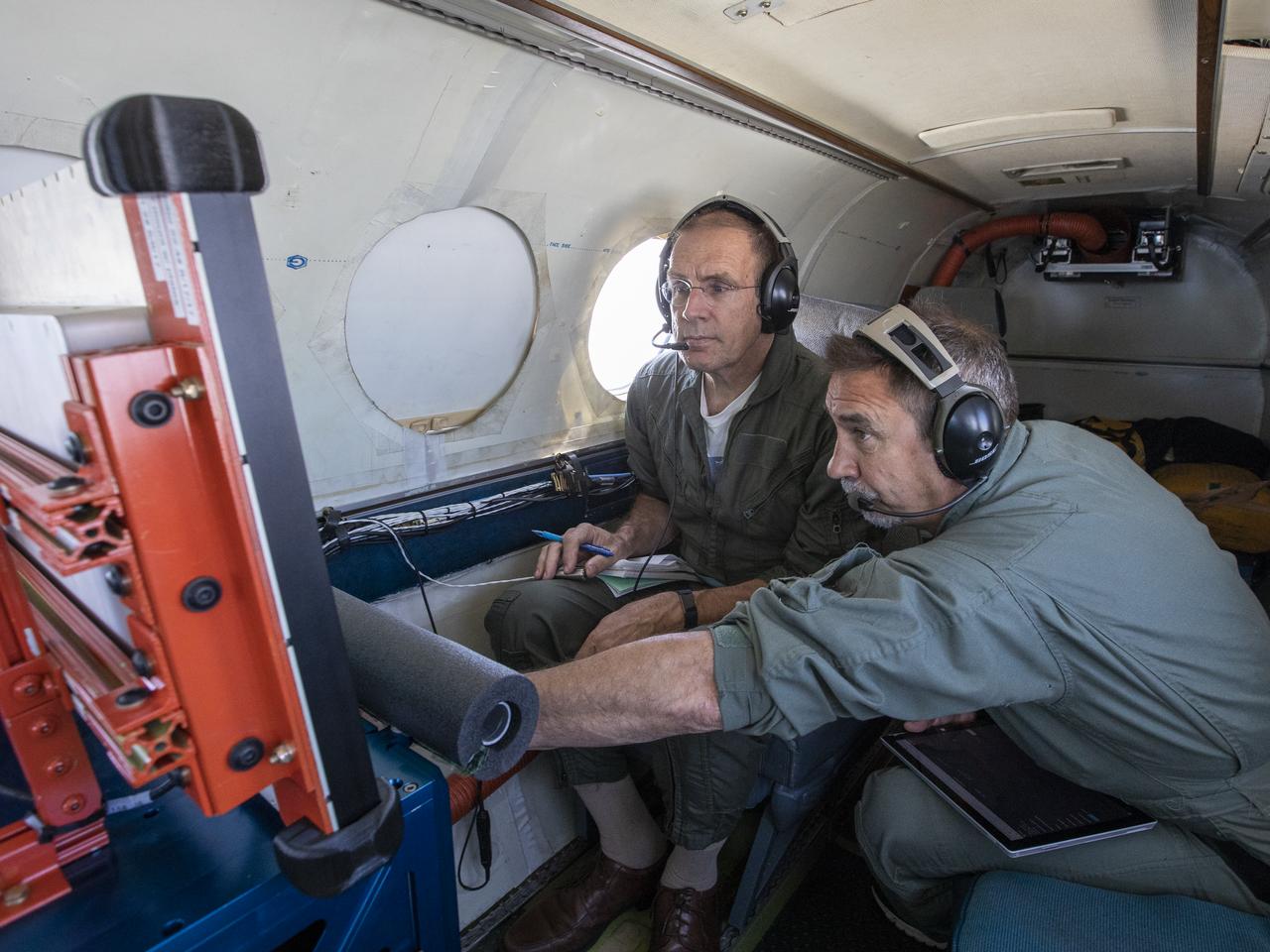 Testing the External Vision System (XVS) software on the B200 King Air. Pilots, Peter Coen and Wayne Ringelberg attempt to spot an incoming aircraft on the XVS monitor.