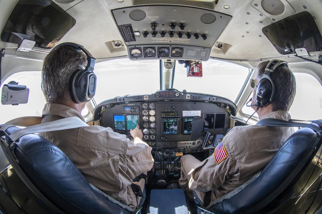 Testing the External Vision System (XVS) software on the B200 King Air. Pilots, Peter Coen and Wayne Ringelberg attempt to spot an incoming aircraft on the XVS monitor.
