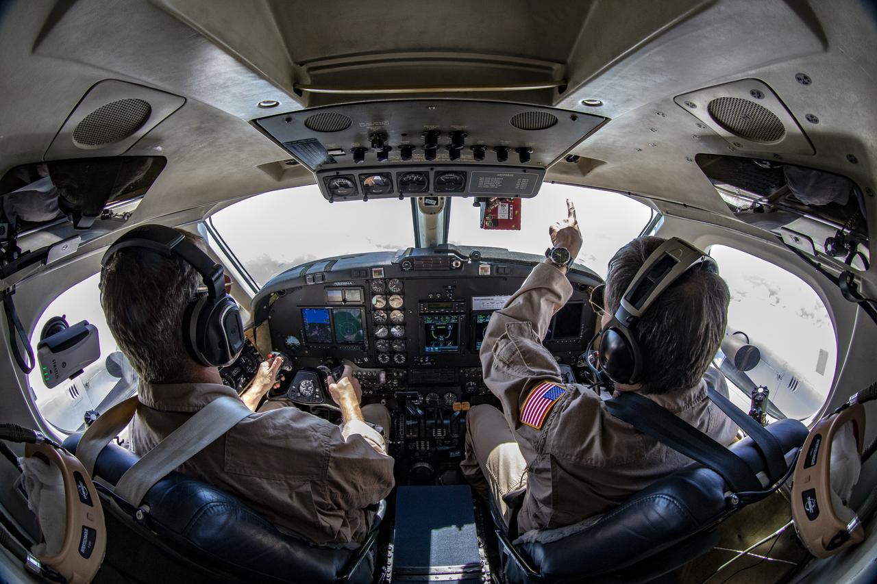 Testing the External Vision System (XVS) software on the B200 King Air. Pilots, Peter Coen and Wayne Ringelberg attempt to spot an incoming aircraft on the XVS monitor.