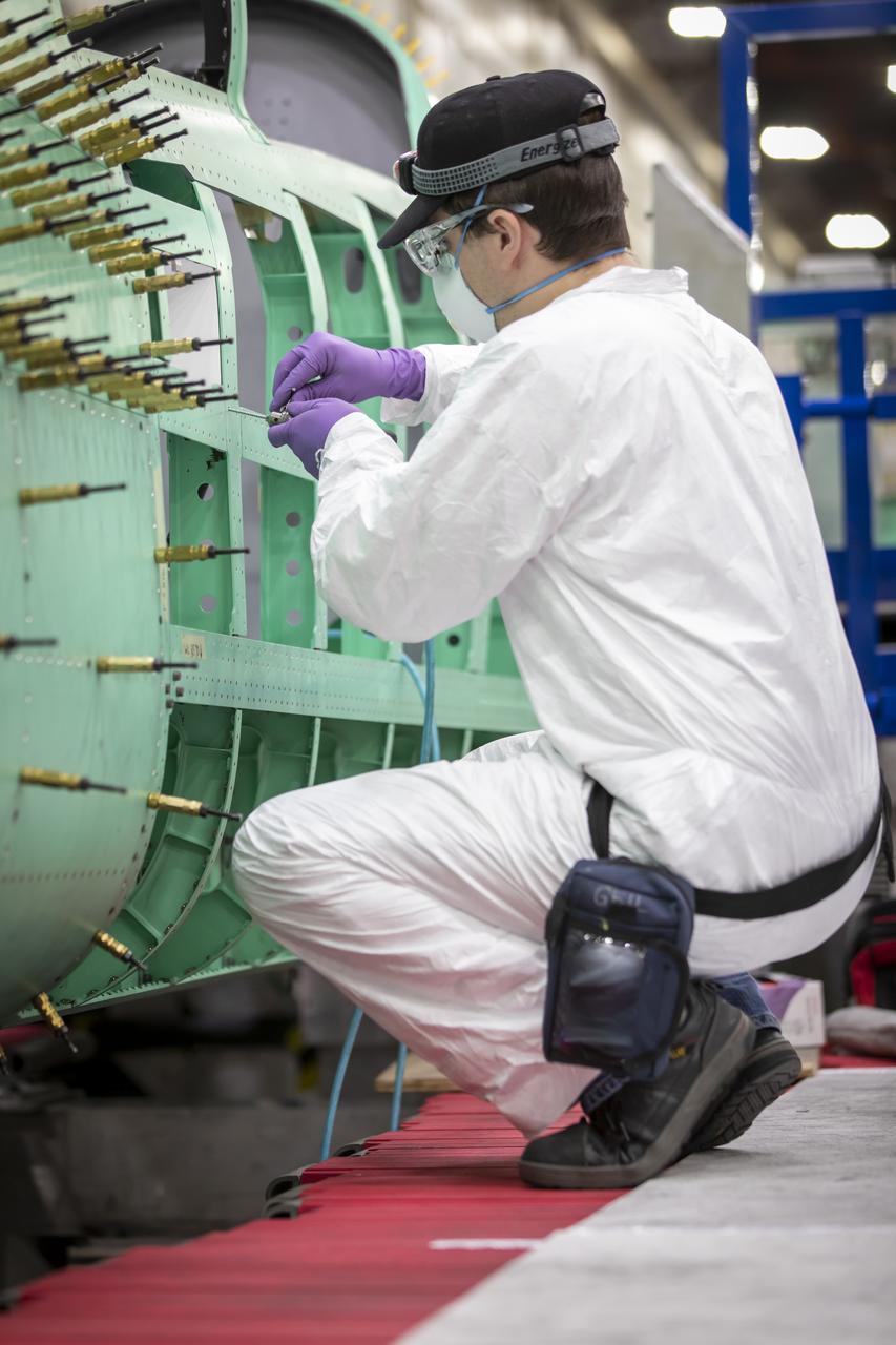 Event: SEG 210 Forebody A Lockheed Martin technician prepares to install the left fuselage skins onto the X-59. Once in the air, the aircraft, currently under construction at Lockheed Martin Skunk Works in Palmdale, California, will demonstrate the ability to fly supersonic while reducing the loud sonic boom to a quiet sonic thump.