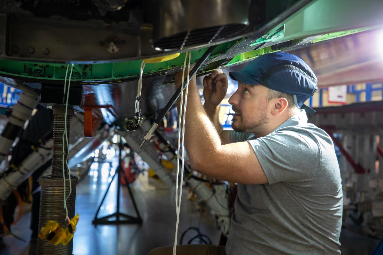 A Lockheed Martin Skunk Works technician works to complete wiring on the X-59 aircraft in preparation for the power-on system checkouts.  Once complete, the X-59 aircraft will demonstrate the ability to fly supersonic while reducing the loud sonic boom to a quiet sonic thump and help enable commercial supersonic air travel over land. This aircraft is the centerpiece of NASA’s Quesst mission.  