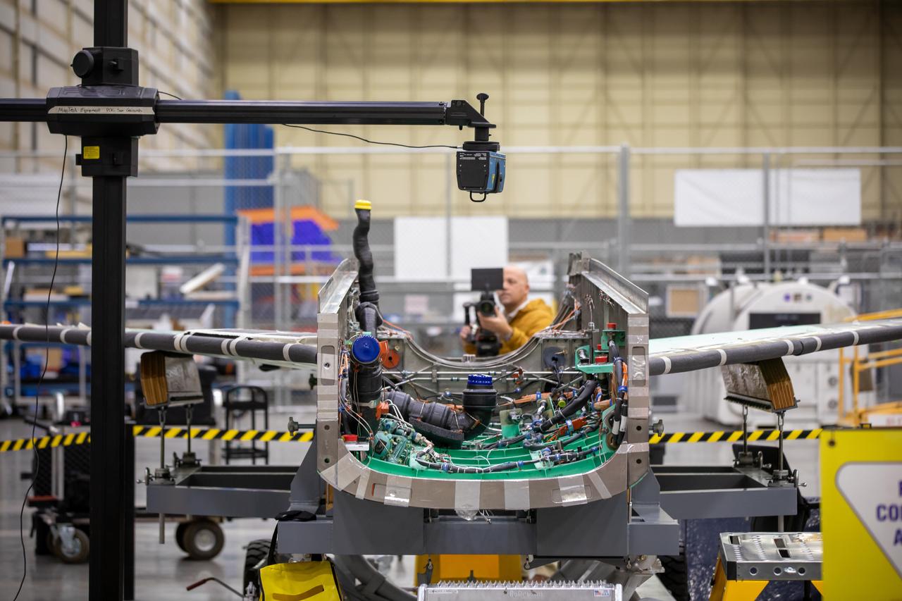 A laser scans the inside of the X-59 aircraft’s lower engine bay at Lockheed Martin Skunk Works in Palmdale, California. These scans can help identify potential hardware or wiring interferences prior to the final installation of the engine and lower tail. 