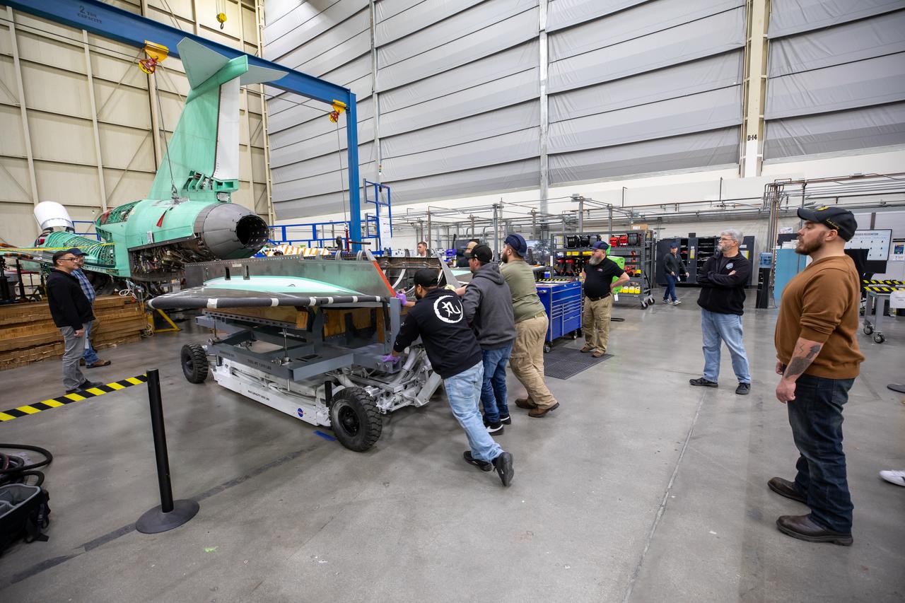 The X-59 team at Lockheed Martin Skunk Works in Palmdale, California, load the lower empennage - the tail section - into place. The surfaces used to control the tilt of the airplane are called stabilators and are connected to the lower empennage. The X-59 is the centerpiece of NASA’s Quesst mission, which could help enable commercial supersonic air travel over land.