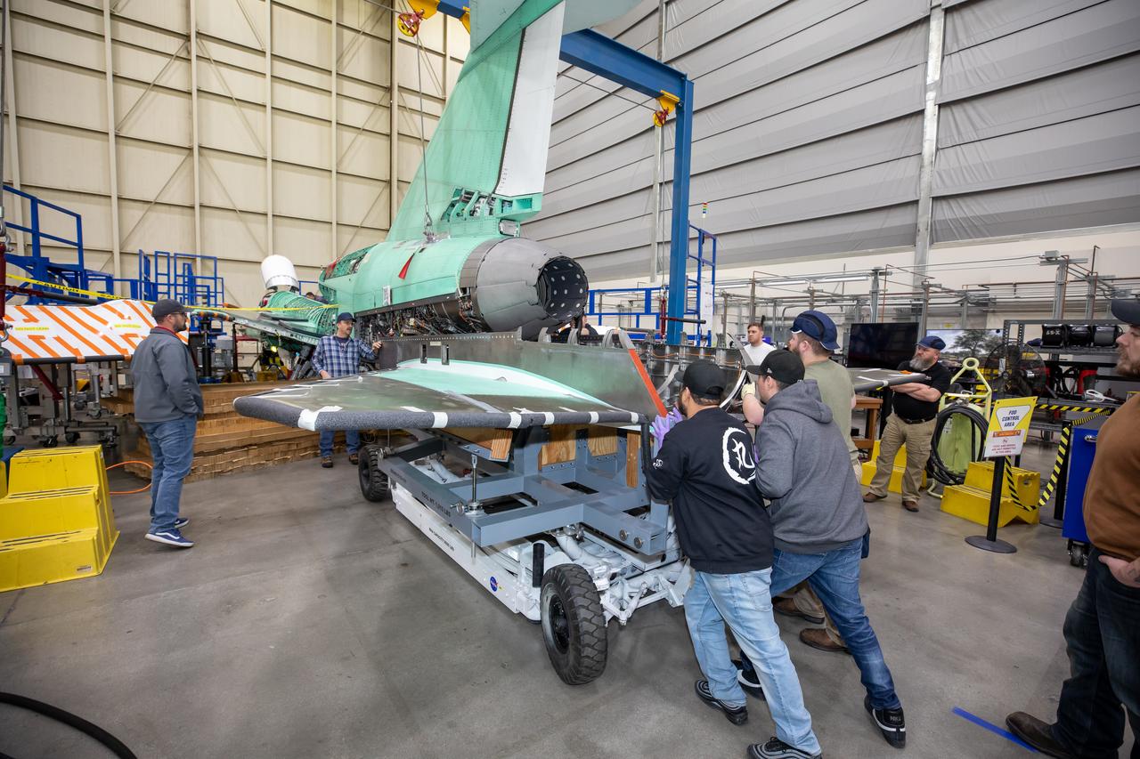 The X-59 team at Lockheed Martin Skunk Works in Palmdale, California, load the lower empennage - the tail section - into place. The surfaces used to control the tilt of the airplane are called stabilators and are connected to the lower empennage.  The X-59 is the centerpiece of NASA’s Quesst mission, which could help enable commercial supersonic air travel over land. 